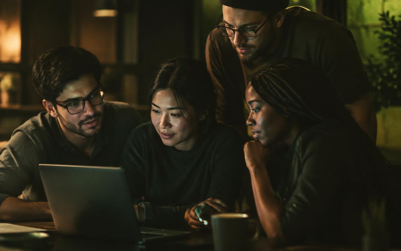 A small team learning together around a laptop